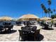 Waterfront patio with tables, chairs, and thatch umbrellas at 1420 Bayshore Blvd # 316, Dunedin, FL 34698