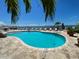 Relaxing freeform pool with patio furniture and water views at 1420 Bayshore Blvd # 316, Dunedin, FL 34698