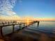 Stunning sunset view over the water with a long dock at 1420 Bayshore Blvd # 316, Dunedin, FL 34698