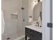 Modern bathroom with marble shower and dark vanity at 1911 Rain Forest Trl, Sarasota, FL 34240