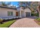 The front elevation of a newly constructed home with a gray garage door at 1911 Rain Forest Trl, Sarasota, FL 34240