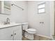 Simple bathroom with a white vanity, toilet and shower at 8540 Zane Ln, Port Richey, FL 34668