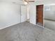 Well-lit bedroom featuring a mirrored closet and neutral carpeting at 5305 Bob White Dr, Holiday, FL 34690