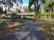 Ranch style home with a long driveway and lush landscaping at 6826 San Jose Loop, New Port Richey, FL 34655