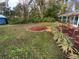 Landscaped backyard with spacious grassy area and garden at 6826 San Jose Loop, New Port Richey, FL 34655