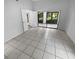 Bedroom with tile flooring and access to a screened porch at 6826 San Jose Loop, New Port Richey, FL 34655