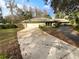 Ranch style home with a large driveway and mature landscaping at 6826 San Jose Loop, New Port Richey, FL 34655