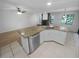Kitchen with granite island, stainless steel dishwasher, and white cabinets at 6826 San Jose Loop, New Port Richey, FL 34655