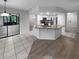 Renovated kitchen with granite island and stainless steel appliances at 6826 San Jose Loop, New Port Richey, FL 34655