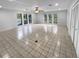 Spacious living room with tile floors and large windows at 6826 San Jose Loop, New Port Richey, FL 34655
