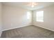 Well-lit bedroom with two windows and carpeted floor at 13628 Covey Run Pl, Spring Hill, FL 34609