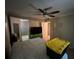 A bedroom with a ceiling fan and carpeting, ready for your personal touch at 16211 3Rd E St, Redington Beach, FL 33708