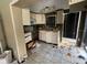 A small kitchen with white cabinets and needs significant renovations at 16211 3Rd E St, Redington Beach, FL 33708