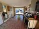 A fixer-upper kitchen with red tile floors and an abundance of natural light at 16211 3Rd E St, Redington Beach, FL 33708