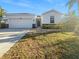 White house with a two-car garage and well-maintained lawn at 3105 46Th E St, Palmetto, FL 34221