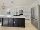 Modern kitchen with island, stainless steel appliances, and dark cabinetry at 3105 46Th E St, Palmetto, FL 34221