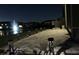 Night view of patio with lake and fountain view at 8955 Milestone Dr, Sarasota, FL 34238