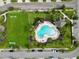 Community pool and playground with surrounding homes visible from above at 1403 Custer Bayou St, Ruskin, FL 33570