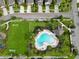 Aerial view showing community pool, playground and surrounding houses at 1403 Custer Bayou St, Ruskin, FL 33570