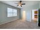 Bright bedroom featuring a large window, ceiling fan and closet at 1403 Custer Bayou St, Ruskin, FL 33570