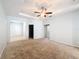 Spacious bedroom with ceiling fan and access to other rooms at 1403 Custer Bayou St, Ruskin, FL 33570