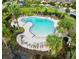 Relaxing community pool with lounge chairs and palm trees at 1403 Custer Bayou St, Ruskin, FL 33570