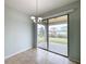 Dining room with tiled floor and sliding glass doors to backyard at 1403 Custer Bayou St, Ruskin, FL 33570