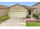 House exterior featuring a two-car garage and landscaped yard at 1403 Custer Bayou St, Ruskin, FL 33570