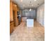 Open kitchen with an island and tile flooring at 1403 Custer Bayou St, Ruskin, FL 33570