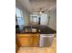 Kitchen island with granite countertop and stainless steel dishwasher at 1403 Custer Bayou St, Ruskin, FL 33570