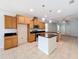 Spacious kitchen with island, granite countertops, and wood cabinets at 1403 Custer Bayou St, Ruskin, FL 33570