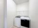 Laundry room with washer and dryer and overhead shelving at 1403 Custer Bayou St, Ruskin, FL 33570