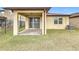 Covered patio with brick pavers and sliding glass door access at 1403 Custer Bayou St, Ruskin, FL 33570