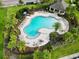 Community pool with plenty of lounge chairs and landscaping at 1403 Custer Bayou St, Ruskin, FL 33570