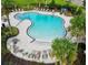 Community pool with lounge chairs and a covered patio at 1403 Custer Bayou St, Ruskin, FL 33570