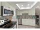 Modern kitchen with stainless steel appliances and white cabinets at 2246 Goldenrod St, Sarasota, FL 34239