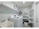 Laundry room with washer, dryer, and ample shelving at 2246 Goldenrod St, Sarasota, FL 34239