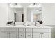 Updated bathroom with double vanity and large mirrors at 72 Windsor Dr, Englewood, FL 34223