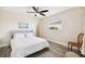 Spacious bedroom with queen-size bed and wood-look floors at 72 Windsor Dr, Englewood, FL 34223