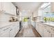 Modern white kitchen with stainless steel appliances and long island at 72 Windsor Dr, Englewood, FL 34223