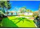 Landscaped backyard with shed and grassy area at 814 15Th Ne St, Ruskin, FL 33570