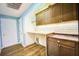 Laundry room with built-in cabinets and countertop at 814 15Th Ne St, Ruskin, FL 33570