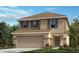 Two-story house with tan siding, gray shutters, and a two-car garage at 10366 Honeysuckle Vine Cir, Riverview, FL 33578