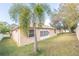 Rear view of a house with a large sliding glass door and a palm tree at 12908 Cattail Shore Ln, Riverview, FL 33579