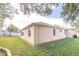 Side view of the house showcasing a well-maintained lawn and stucco exterior at 12908 Cattail Shore Ln, Riverview, FL 33579