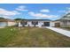 Newly renovated home with a gray garage door and white exterior at 5116 Lillilea Ln, New Port Richey, FL 34653