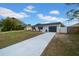 Newly renovated home with a gray garage door and white exterior at 5116 Lillilea Ln, New Port Richey, FL 34653