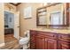 Bathroom boasts granite countertop, wood cabinets, and large mirror at 6437 Alcester Dr, New Port Richey, FL 34655