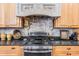 Detailed view of the kitchen's gas cooktop and ornate range hood at 6437 Alcester Dr, New Port Richey, FL 34655