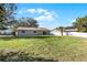 House with a large backyard and a white fence at 7939 Riverdale Dr, New Port Richey, FL 34653